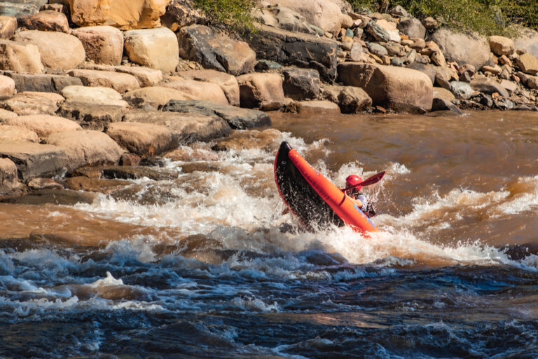 Kayak popping wheelie through Smelter White Water Park - Lower Animas