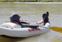 Man lounging in his kayak in Castle Valley, Moab, Utah - Mild to Wild