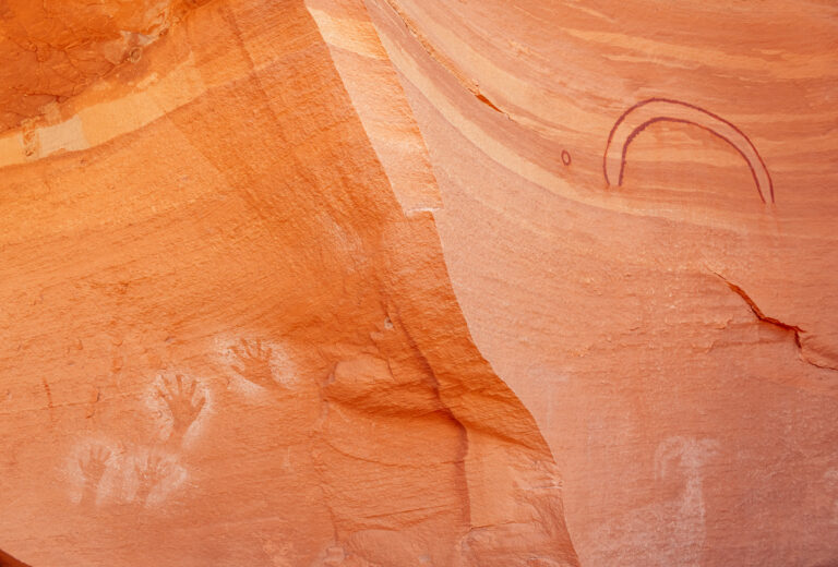 Pictographs of hands and arc on red sandstone in Cataract Canyon, Utah 