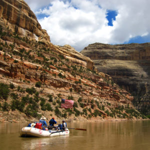 a raft floating through the yampa river canyon