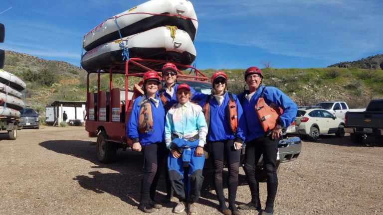 Group photo in front of Mild to Wild boats at the Salt River office