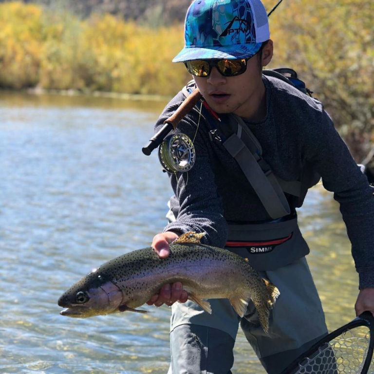 Man holding a rainbow trout - Durangers fly fishing tours - Mild to Wild