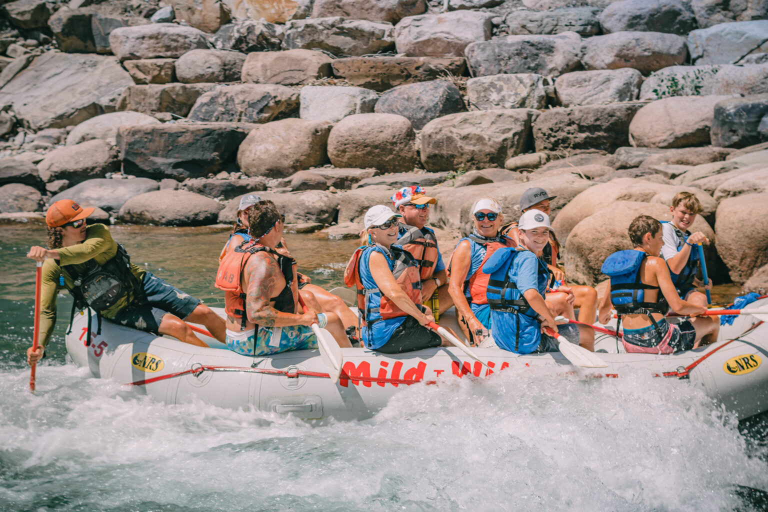 raft guide navigating guests through Lower Animas rapid - Mild to Wild