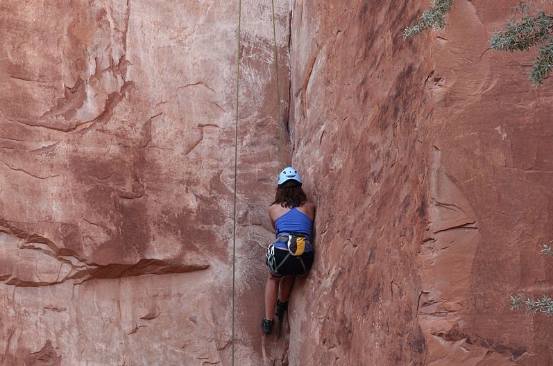 woman climbing crack on Potash Road, Moab - Mild to Wild