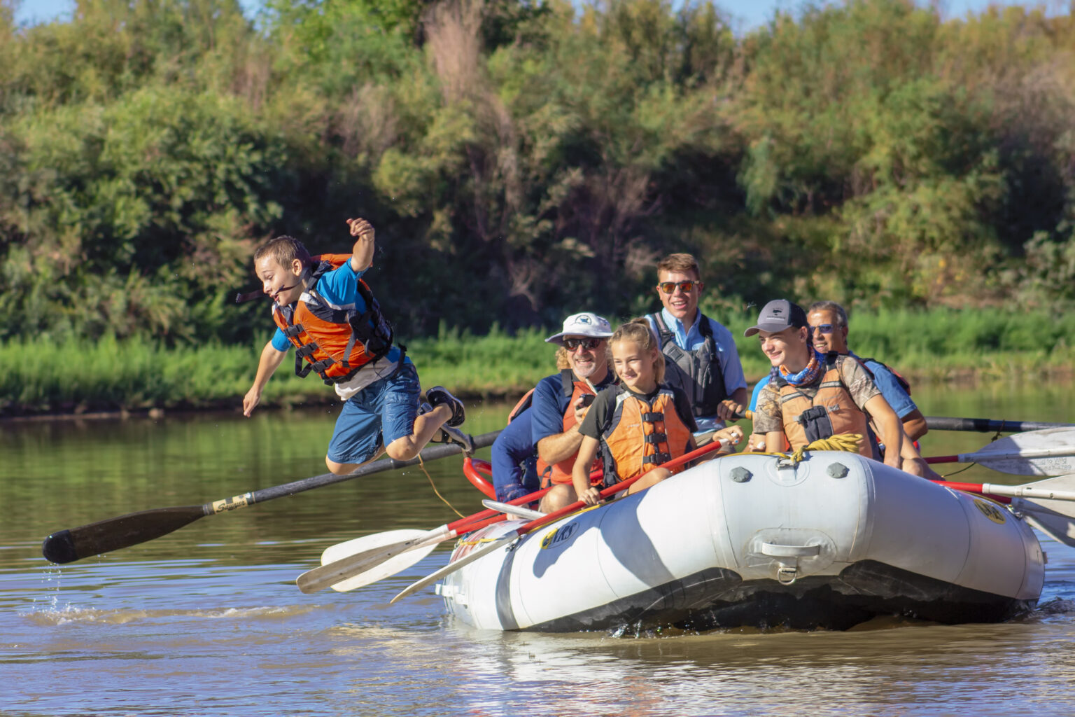 Castle Valley, Utah rafting - close up of boy jumping off the raft into the water