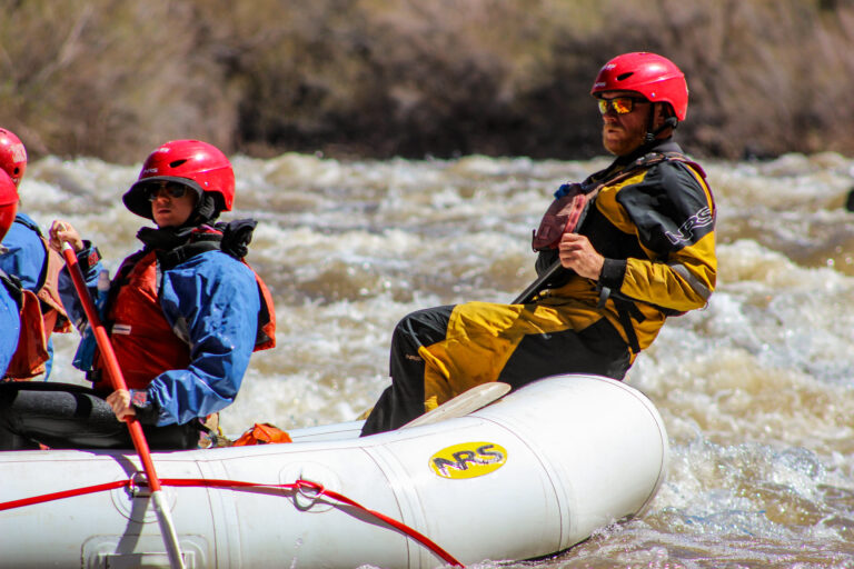 Salt River guide paddling back of boat - Mild to Wild Rafting 