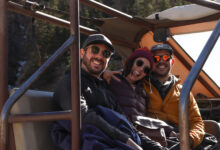 close up of Three people smiling in the back of a jeep