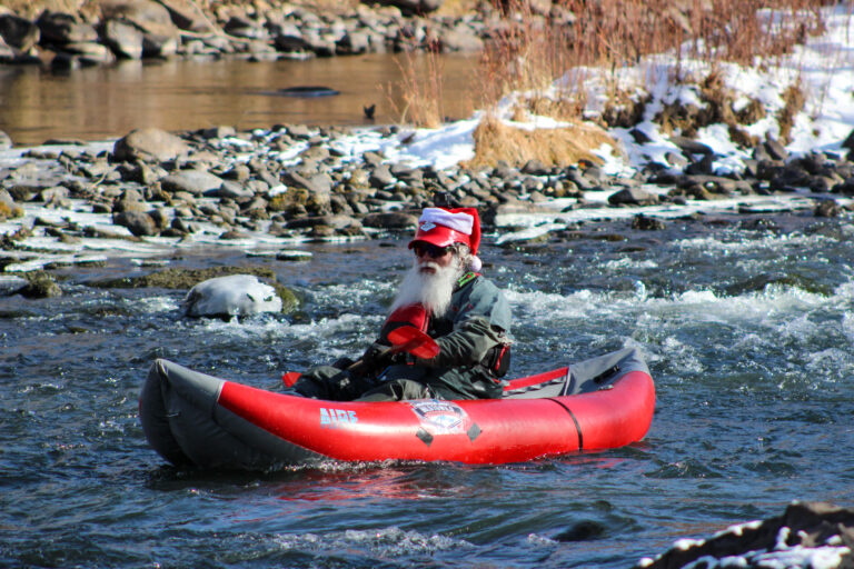 Santa Claus kayaks down the Lower Animas in winter in Durango, Colorado - Mild to Wild 