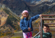 Young girl and boy smile while in the back of a Jeep on a Silverton Jeep Tour - Mild to Wild