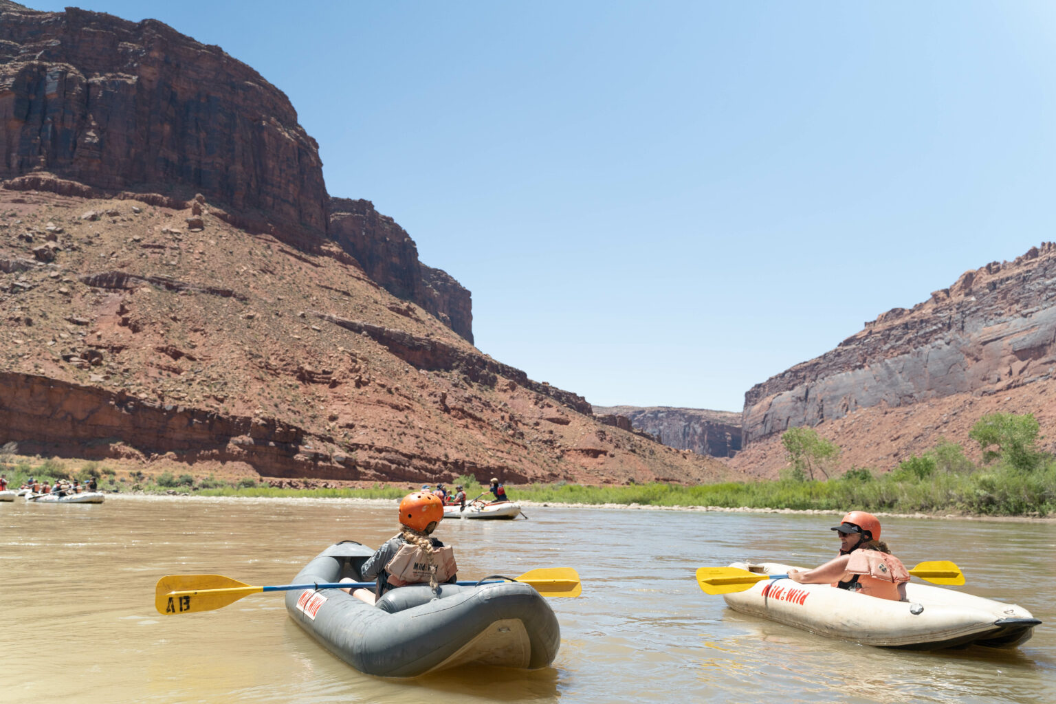 Two inflatable kayakers on the colorado river in castle valley, moab Utah