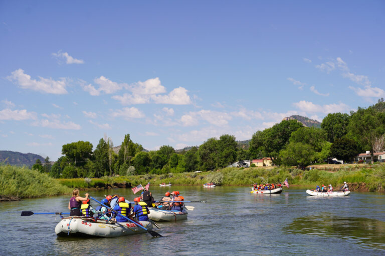 Boats floating down the Lower Animas River for a Durango Rafting trip