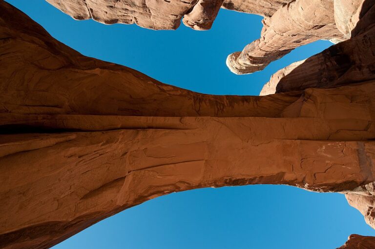 Angle looking straight up underneath Tower Arch in Arches National Park, for more insider tips about Arches 